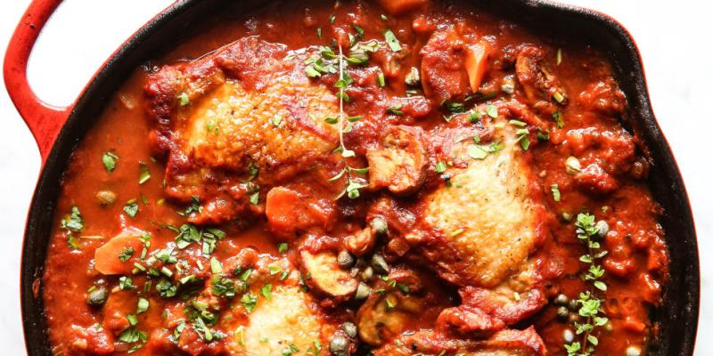 A skillet of chicken cacciatore in red sauce from Buona Sera