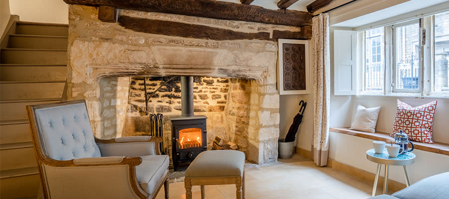 A cosy living room with wood burning stove at Bolthole Retreats