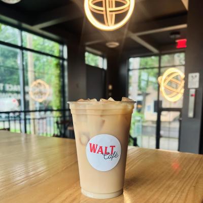 iced coffee on a table with walt cafe sticker on it