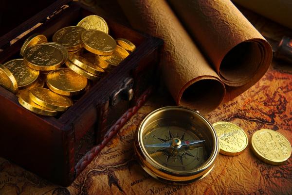Picture shows gold coins, scroll and compass