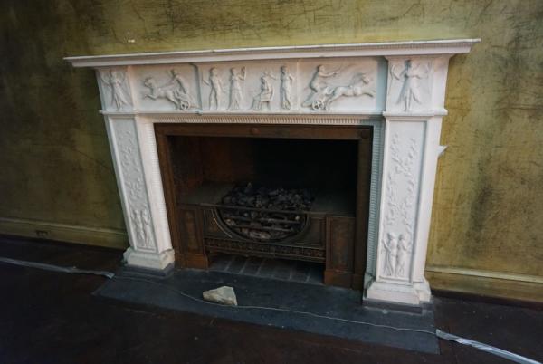 Eugenia Williams House Fireplace with engravings of people around edges