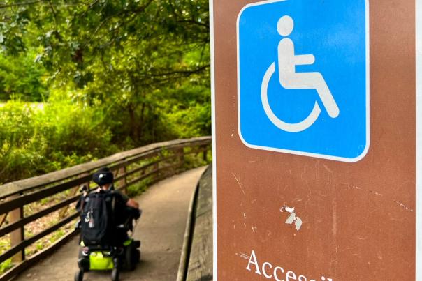 Cory riding through the wheelchair accessible pathway.