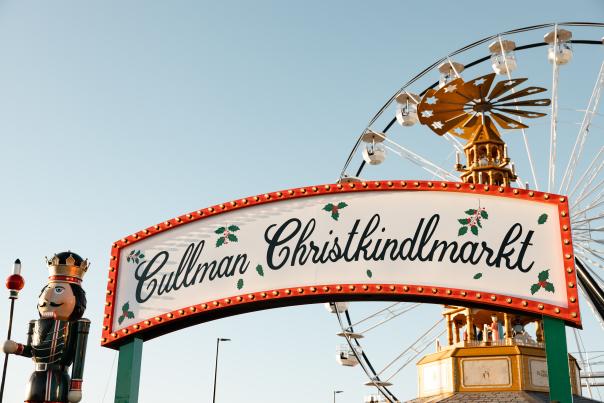 Cullman Christkindlmarkt sign and nutcracker with the ferris wheel in the background