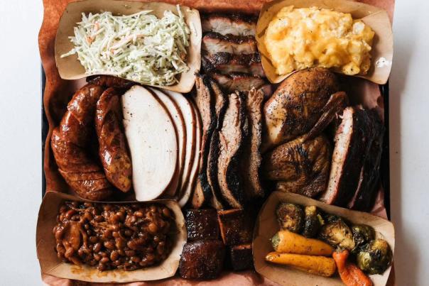 Delicious barbecue plate featuring different meats, slaw, macaroni and cheese, baked beans, and other veggies from Russell's BBQ in Sheffield.
