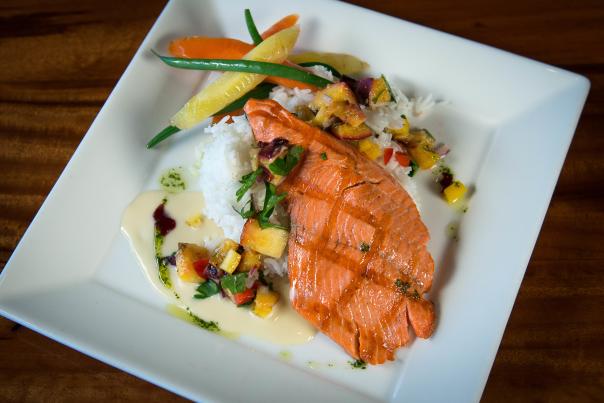 Grilled salmon plated at Haute Quarter Grill