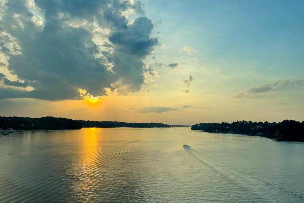 Blue, green, and yellow hues of the sky during a sunset over the Severn River