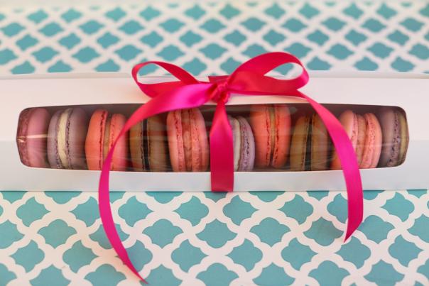 Macarons in a box with a bow.