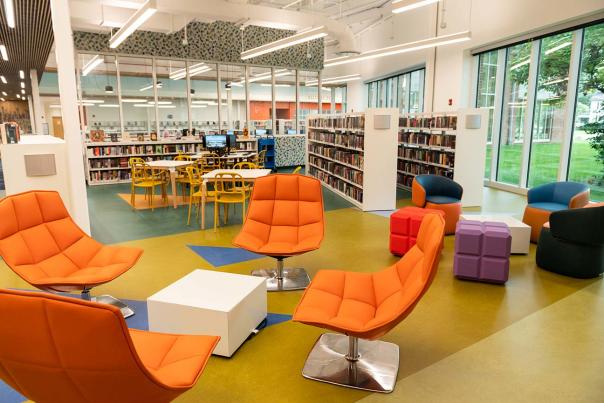 A loung area with four orange chairs at the Michael Busch Library in Annapolis