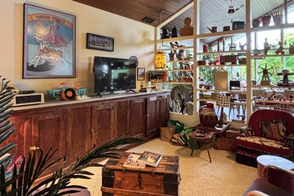 interior of bed and breakfast building with tan walls, wood cabinets and tables, wood ceiling panels.