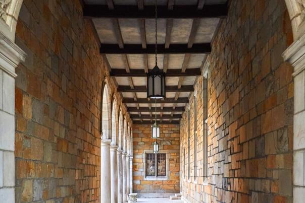 A view down a hallway of an exterior of a campus building.