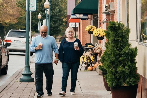 Couple in walking on sidewalk along Chelsea main street