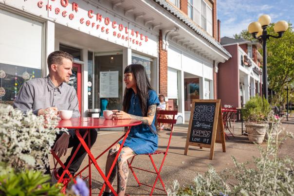 a couple sits outside of Condor Chocolates in the Five Points neighborhood of Athens, GA.