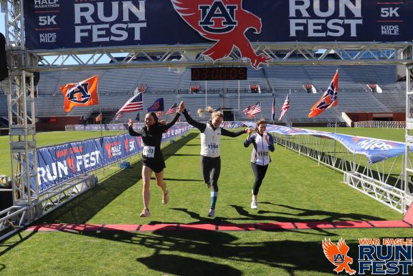 three girls crossing the finish line at War Eagle Run Fest