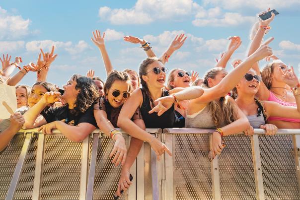 Crowd of young women against the festival barricade in front of stage at ACL Music Festival