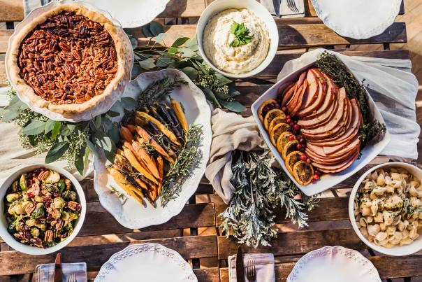 Holiday spread from Walton's Fancy and Staple showing Glazed Ham, Mac and Cheese, Brussels Sprouts with Prosciutto, Carrots and a Pecan pie