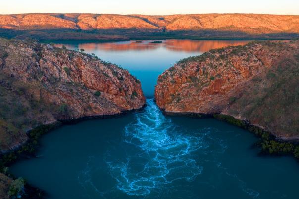 A drone image showing water flowing through the wide gap of Garaanngaddim Horizontal Falls on the Kimberley Coast