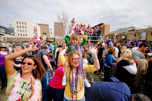 Kids and families sporting lots of beads and having fun during Mardi Gras events