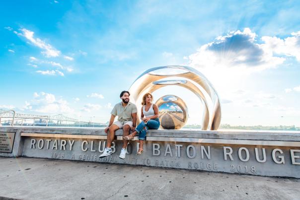 two people at the Sing the River sculpture