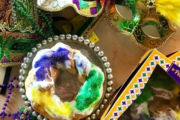 King Cakes have been frosted and decorated with green, gold and purple sprinkles for a festive Mardi Gras look.