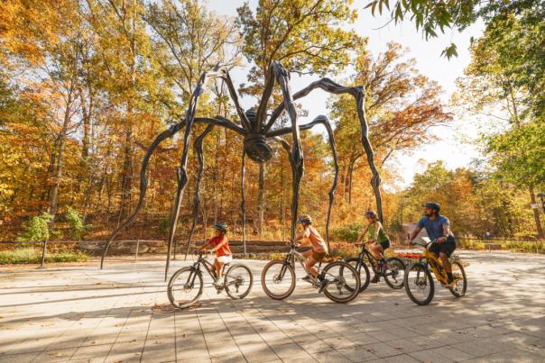 Family at Crystal Bridges in the Fall on Bikes