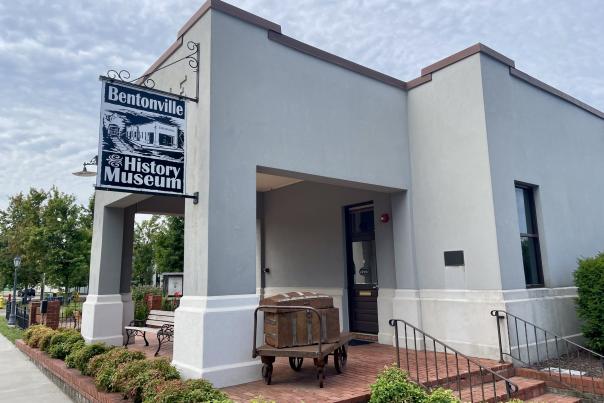 Historic Train Depot front porch, painted gray with red brick patio.