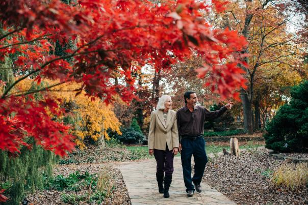 A couple walking the grounds of Baker Arboretum during the fall in Bowling Green, Ky.