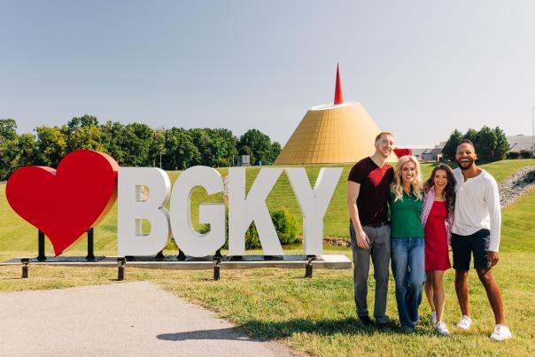 Group of friends posing in front of a sign that reads, "HeartBGKY." Located in front of the National Corvette Museum in Bowling Green, Kentucky.