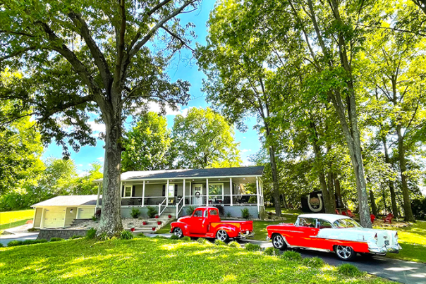 Cherry-red hot rods sit in the diveway of the Horsepower Hangout rental home in Bowling Green, KY.