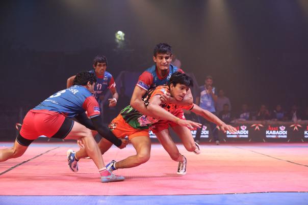 Four people playing kabaddi