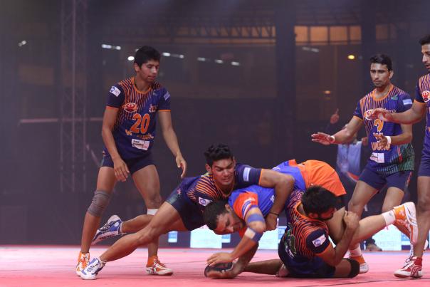 Kabaddi game being played on a indoor court