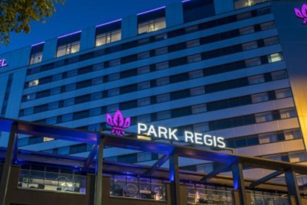 The Park Regis hotel from outside, at night, looking up from ground level at the building above