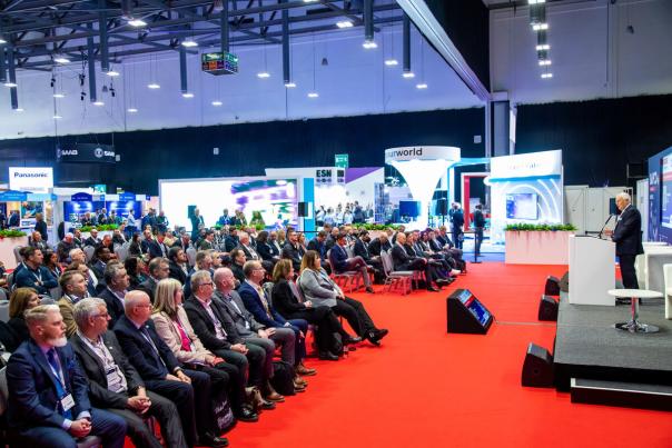 Delegates seated listening to a speaker at a conference