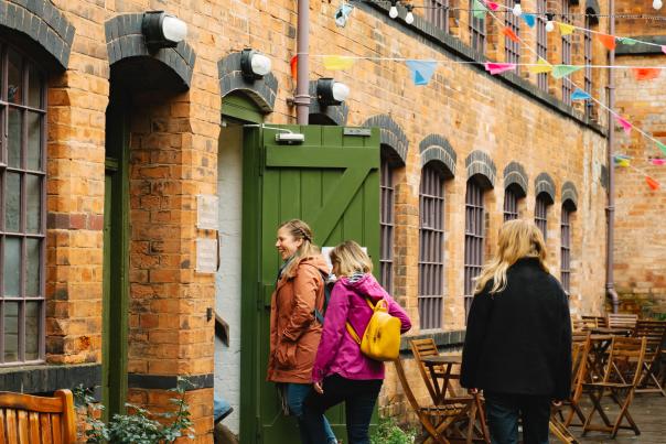 Three women walk into a building.