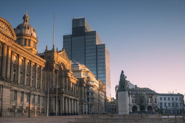 Early morning in Victoria Square, Birmingham, showing council house and statue of Queen Victoria in front of 103 Colmore Row in the distance.