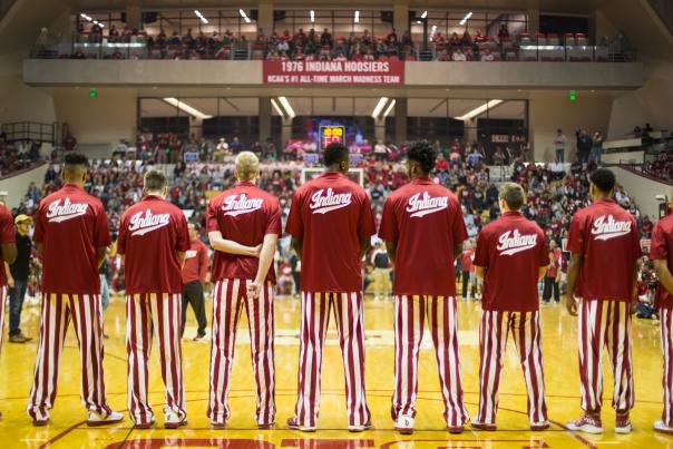 The IU Men's Basketball team standing side by side on court prior to a game