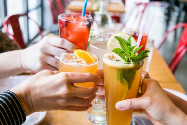 Four people cheersing cocktails at Cardinal Spirits