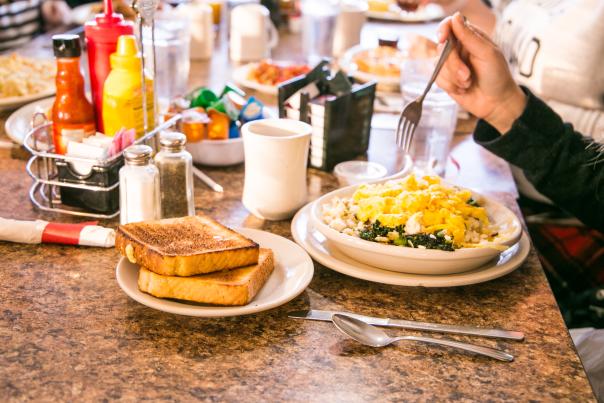 A table full of people with breakfast dishes at Cozy Table