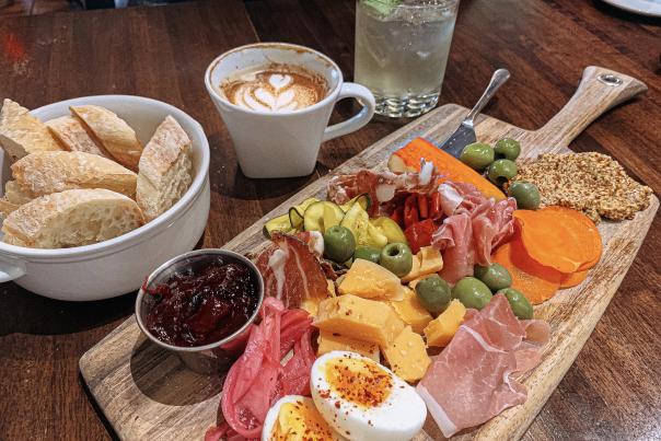 A charcuterie board, latte, and mojito from Feast Market & Cellar