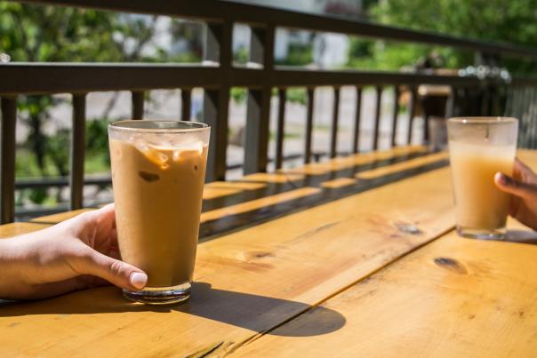 Two people enjoying iced coffee from Hopscotch Coffee