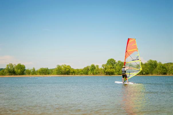 A man windsurfing on Monroe Lake