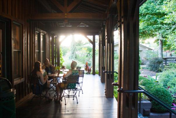 Three women sitting at a table on Oliver Winery's patio