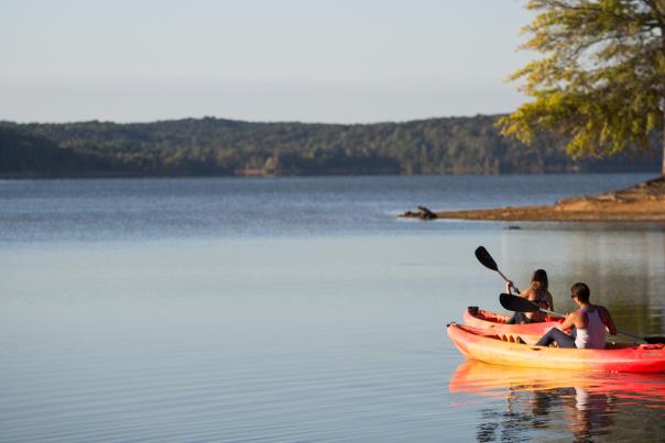 People In Canoe On Lake