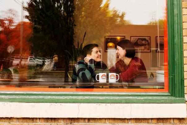 Couple in Rainbow Bakery Window