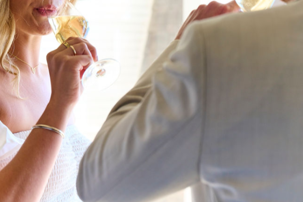 couple enjoying a glass of champagne in their hotel room