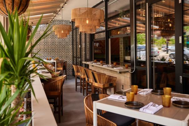 Covered patio with woven basket lighting and plants at Cozobi Fonda Fina