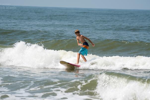 a kid surfing on Ocean Isle Beach
