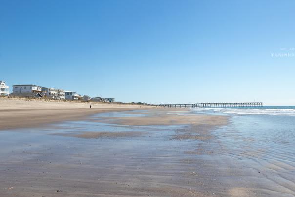 an empty and wide open beach on Oak Island, NC