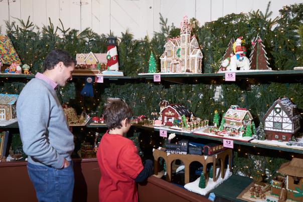 Families enjoy the Gingerbread House display at Peddler's Village.