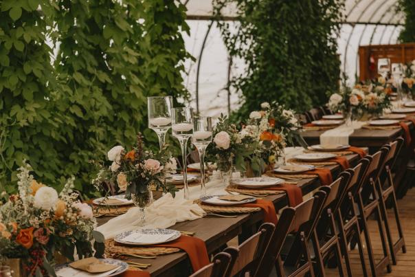 Of the Land is a farm, event venue and caterer. They have a Green Box, which uses products from local farms. Weddings, open houses, yoga -- the greenhouse venue has many uses. There is a garden with seating, bonfire spaces and a farmhouse. Photos 2022