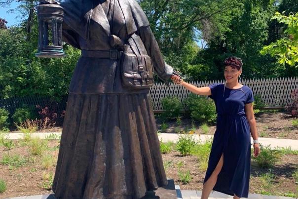 Women holding Harriet Tubman's Hand